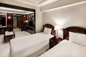 a hotel room with two beds and a television at Gangnam Artnouveau City in Seoul +23 photos