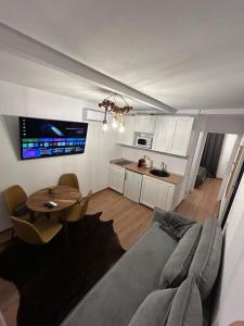 a living room with a couch and a table at Tiny Cozia Caciulata in Caciulata +11 photos