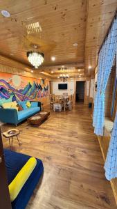a living room with a blue couch and a table at Akari Inn in Haripūr
