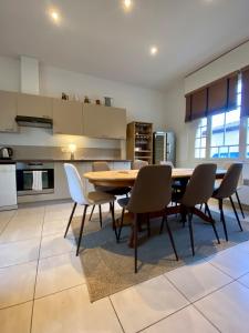 a dining room with a wooden table and chairs at Maison de vacances, centre ville Gambetta in La Teste-de-Buch +17 photos