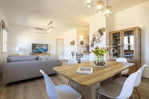 a living room with a table and a couch at Raphael's Boutique Stay in Palau