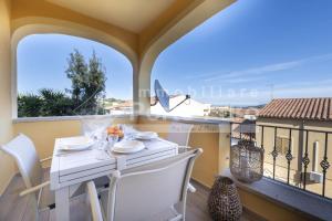 a table and chairs on a balcony with a view at Raphael's Boutique Stay in Palau