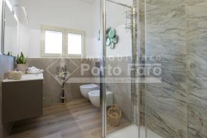 a bathroom with a glass shower and a toilet at Raphael's Boutique Stay in Palau +34 photos