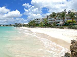 a hotel on the beach next to the ocean at Coral Sands Beach Resort in Bridgetown