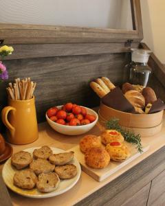 a table with two plates of bread and a bowl of tomatoes at Masseria Mezzamira in Pezze di Greco