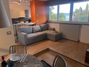 a living room with a couch and a table at Inaya Apartment in Oggebio +14 photos