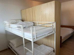 a bunk room with two bunk beds in it at Inaya Apartment in Oggebio