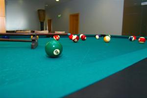 a billiard table with a line of balls on it at Golden Residence Hotel in Funchal