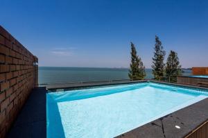 a swimming pool on top of a building with the water at Sandbox Beachfront Villa 6 in Ban Krathing Lai