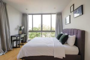 a bedroom with a bed and a large window at Sandbox Beachfront Villa 6 in Ban Krathing Lai +15 photos