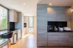 a kitchen with stainless steel cabinets and a microwave at Sandbox Beachfront Villa 6 in Ban Krathing Lai