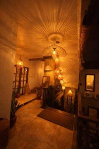 a living room with a ceiling with a chandelier at Tendan Residence in Legian