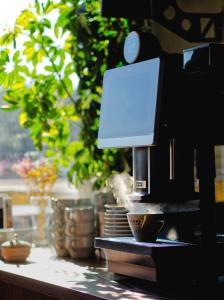 a coffee machine sitting on top of a counter at Hotel Tor Kielce in Kielce