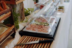 a buffet with a plate of meat and vegetables at Gut Herzogberg in Sonntagberg