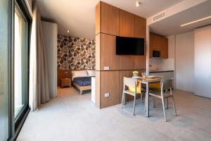 a small room with a table and a bedroom at G Palace Residence in Civitanova Marche