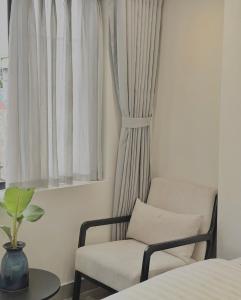 a room with a chair and a window at PHAM Homes in Hai Phong +22 photos