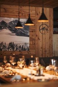 a dining room with a table and some lights at Alpin Peaks in Turracher Hohe