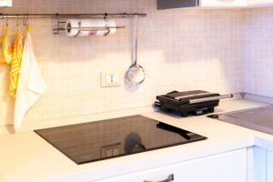 a kitchen counter with a sink in a kitchen at Villino Joy in Stintino +37 photos