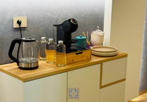 a kitchen counter with a coffee maker on it at Passo Lento Charme Rooms in Gravina in Puglia