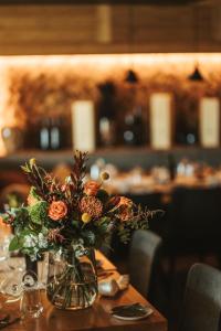 a vase filled with flowers sitting on a table at Alpin Peaks in Turracher Hohe