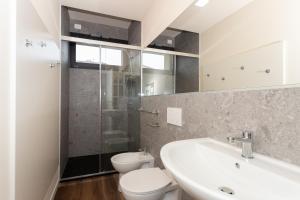 a bathroom with a sink and a toilet and a shower at Palazzo Mazzini in Cornaredo