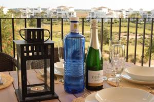a table with a bottle of wine and glasses at Casa Serena - Sucina in Sucina