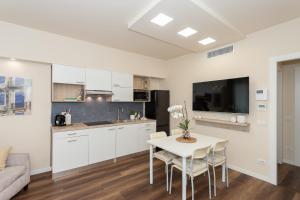 a kitchen and living room with a table and chairs at Palazzo Mazzini in Cornaredo +28 photos