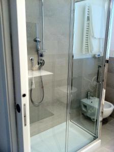 a shower with a glass door in a bathroom at Residence Ormeggio in Grado