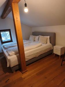 a bedroom with a bed with a wooden beam at Apartment King Louie in Prien am Chiemsee