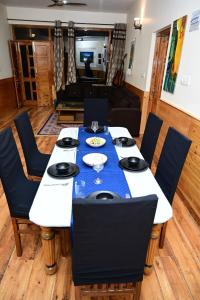a dining room table with a blue table cloth at Akari Inn in Haripūr