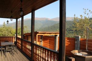 eine überdachte Veranda mit Bergblick in der Unterkunft Jans in Dilidschan