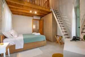 a small bedroom with a bed and a staircase at MERAKI residence in Atsipopoulo