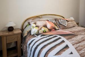 a bed with a wooden headboard and pillows on it at La casa di Ros in Perinaldo