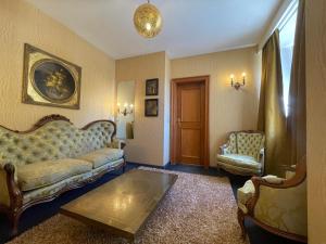 a living room with a couch and two chairs at Oranienburg Vintage Hotel - Private Garden Residence in Vianden