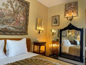 a bedroom with two beds and a large mirror at Oranienburg Vintage Hotel - Private Garden Residence in Vianden