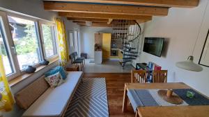 a living room with a table and a dining room at Südalpen Lofts in Bleiburg