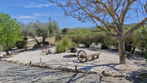 a park with a bench and a wheel in the sand at Casa La Alegria 37 in Málaga
