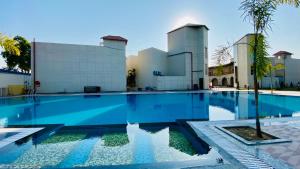 a swimming pool in front of a building at Shree Anantay Club & Resort in Ujjain