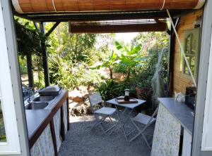 a patio with a sink and a table and chairs at Chez Evelyne et Thierry in Saint-Leu +24 photos