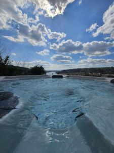 a large pool of water with a view of a river at La Bâtie - Jacuzzi - Vue - Amazing view - Parking privé in Vienne