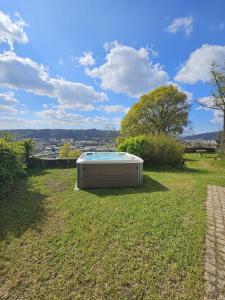 a tub sitting on the grass in a field at La Bâtie - Jacuzzi - Vue - Amazing view - Parking privé in Vienne +88 photos