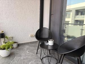 two chairs and a table on a balcony at Blue Diamond Luxe in Gaborone