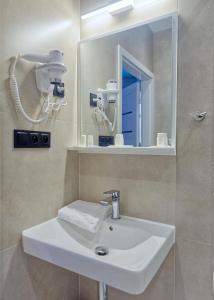 a bathroom with a white sink and a mirror at Hotel Tor Kielce in Kielce +32 photos