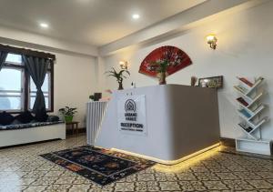 a living room with a reception desk in a room at Urbane Haauz in Pelling