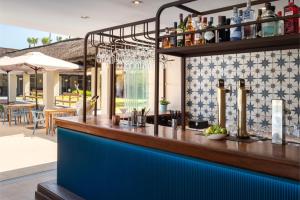 a bar at a restaurant with a blue counter at Vincci Resort Costa Golf in Chiclana de la Frontera