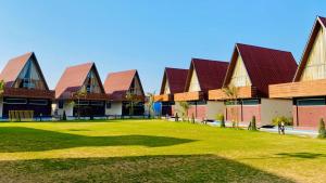 a row of buildings with a grass yard at Shree Anantay Club & Resort in Ujjain