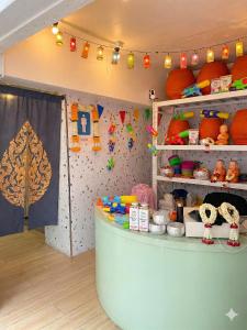 a room with a counter with toys on shelves at Bangkok Group Bunk Hotel Khaosan in Bangkok