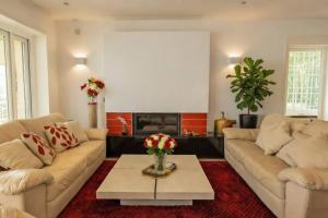 a living room with two couches and a coffee table at August Villa Málaga. Relax Playa Piscina Coworking in Málaga