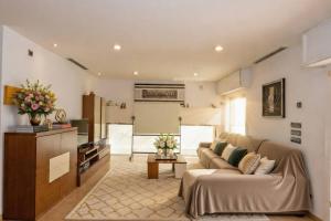 a living room with a couch and a table at August Villa Málaga. Relax Playa Piscina Coworking in Málaga +43 photos
