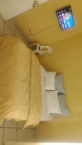 a bed in a room with a tv on the ceiling at METINAT GUEST HOUSe in Groblersdal